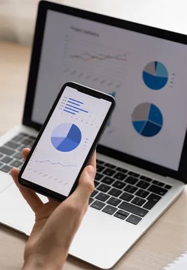 Reviewing website analytics on a laptop and phone